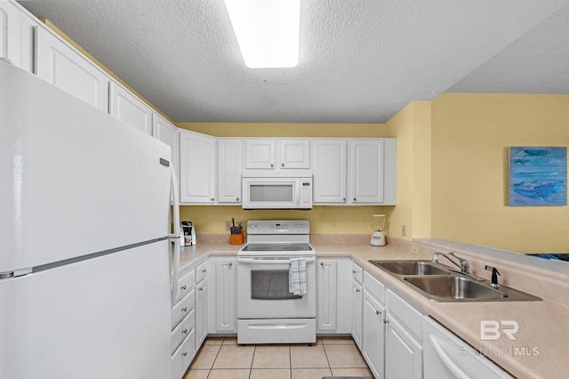 kitchen with white cabinetry, a textured ceiling, light tile patterned floors, and white appliances