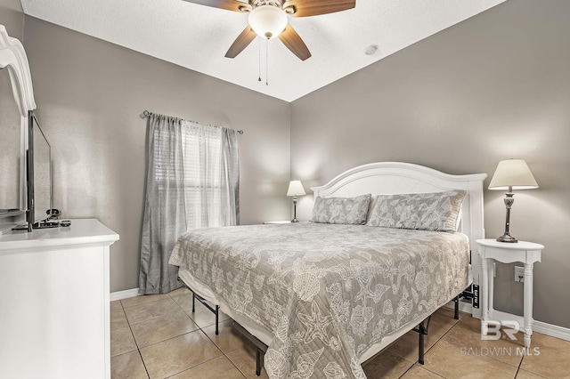 tiled bedroom featuring ceiling fan and lofted ceiling