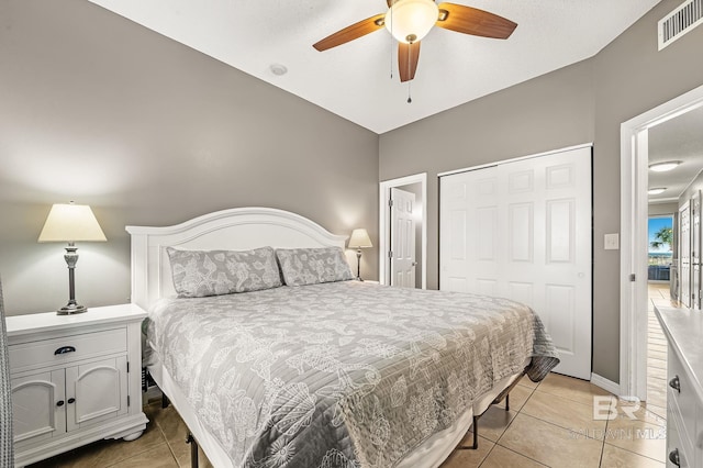 tiled bedroom with a closet and ceiling fan