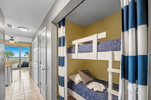 tiled bedroom with a textured ceiling