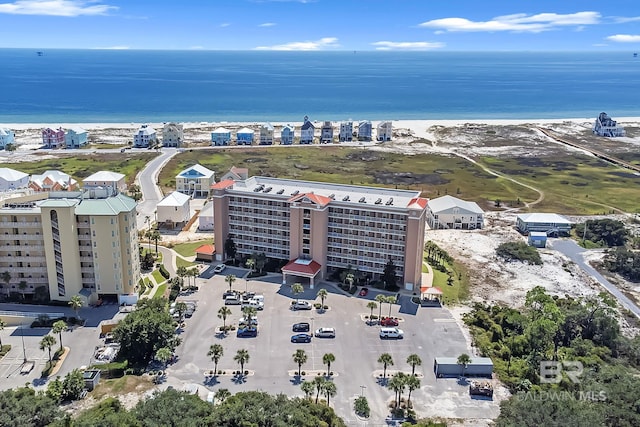 birds eye view of property with a water view and a view of the beach