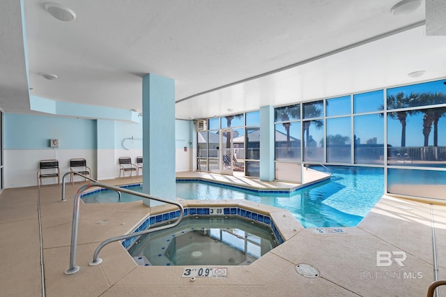 view of swimming pool with an indoor hot tub