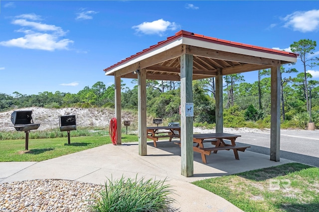 view of home's community with a gazebo, a patio area, and a lawn