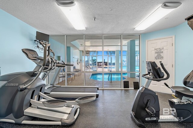 exercise room featuring a textured ceiling