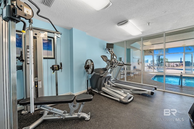 workout area featuring a textured ceiling