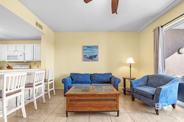 living room featuring light tile patterned flooring and ceiling fan