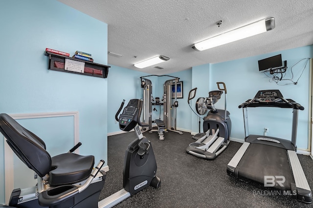 workout area featuring a textured ceiling