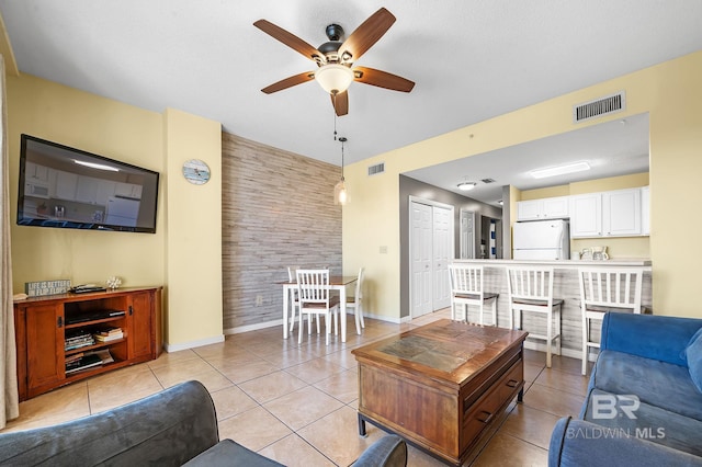 living room with light tile patterned floors and ceiling fan