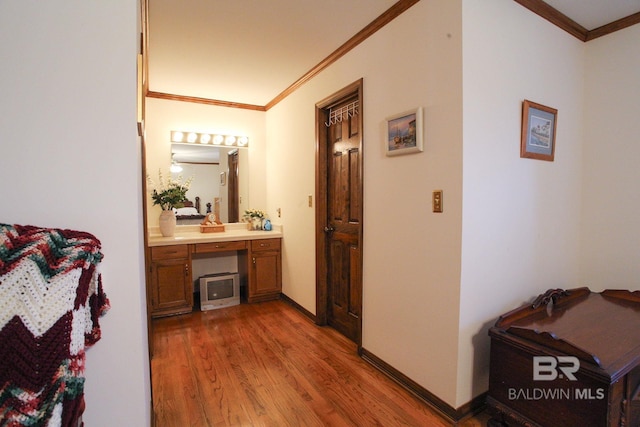 bathroom featuring crown molding, hardwood / wood-style floors, and vanity