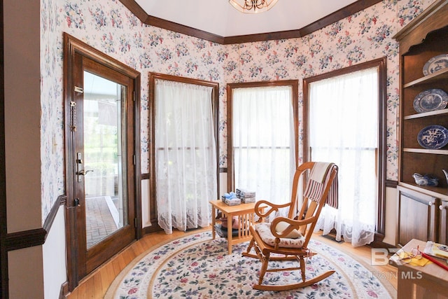 living area featuring plenty of natural light, french doors, and light hardwood / wood-style floors