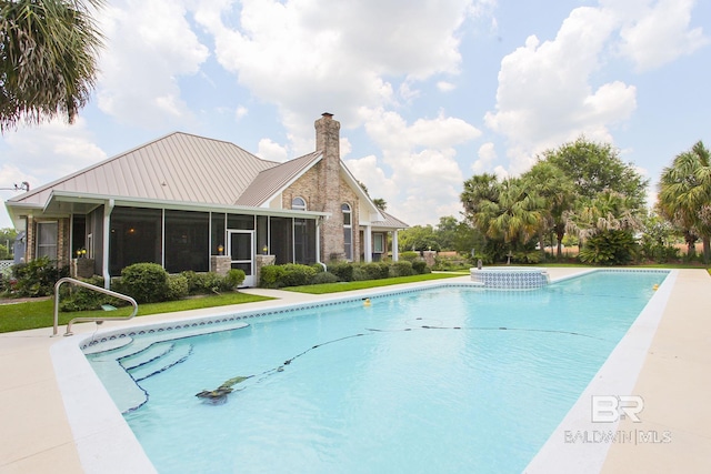 view of swimming pool featuring a sunroom