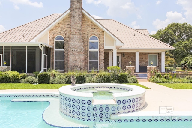 exterior space featuring an in ground hot tub