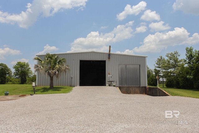 view of outbuilding featuring a garage and a yard