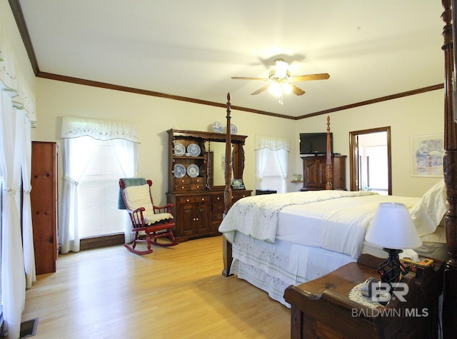 bedroom with ornamental molding, multiple windows, ceiling fan, and light wood-type flooring