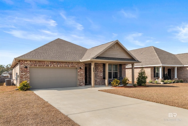 view of front of home featuring a garage and central AC