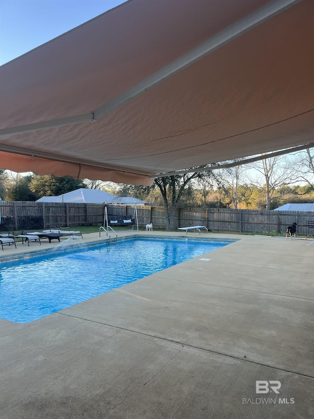 view of pool with a patio area, a fenced backyard, and a fenced in pool