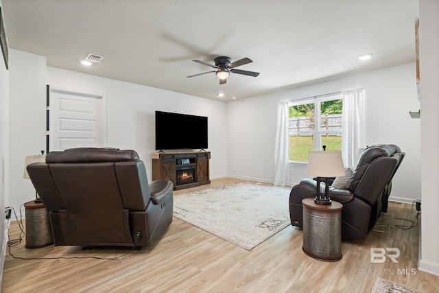 2526 E Windmere Dr, Semmes, AL 36575 - living area featuring ceiling fan, light wood-style flooring, a lit fireplace, recessed lighting, and baseboards