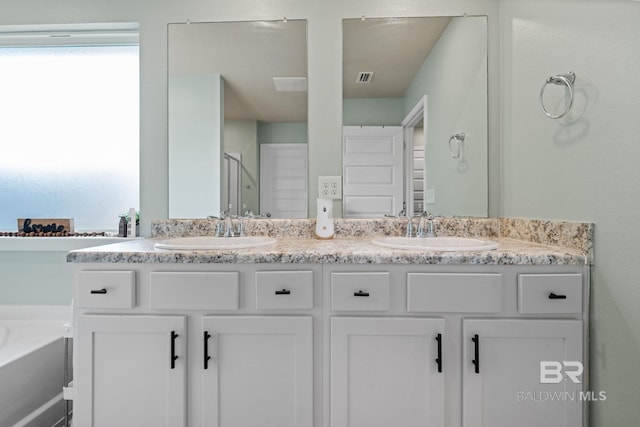2526 E Windmere Dr, Semmes, AL 36575 - bathroom featuring double vanity, a bath, and an enclosed shower