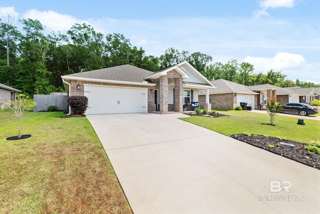 2526 E Windmere Dr, Semmes, AL 36575 - view of front facade with brick siding, an attached garage, driveway, and roof with shingles