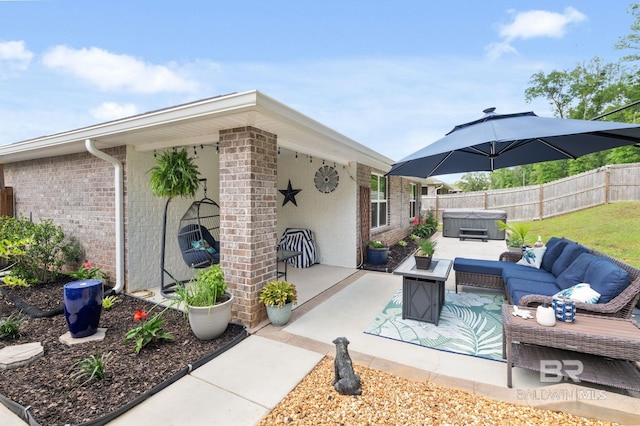2526 E Windmere Dr, Semmes, AL 36575 - view of patio / terrace featuring a hot tub, fence, and outdoor lounge area