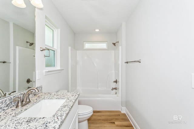 full bathroom featuring hardwood / wood-style flooring, vanity, shower / bathtub combination, and toilet