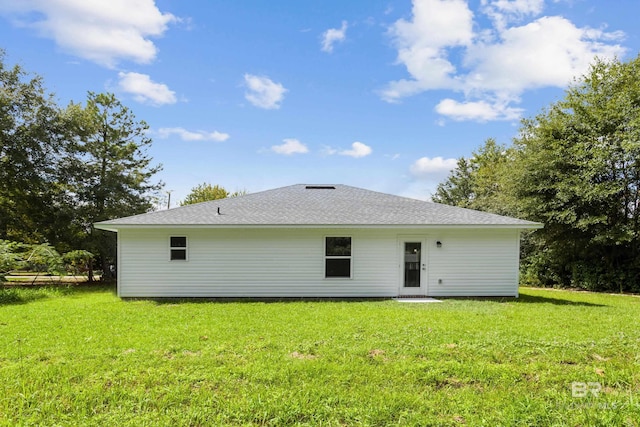 back of house with a lawn