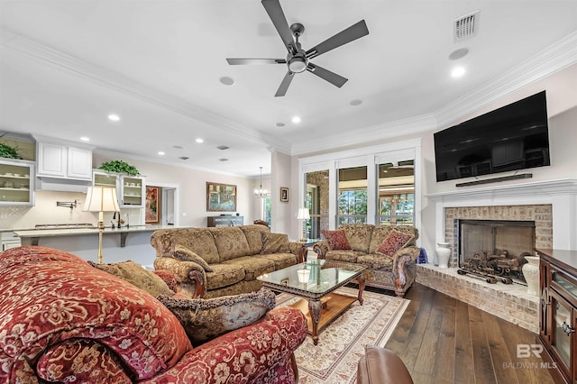 living area featuring recessed lighting, a fireplace, crown molding, a ceiling fan, and visible vents