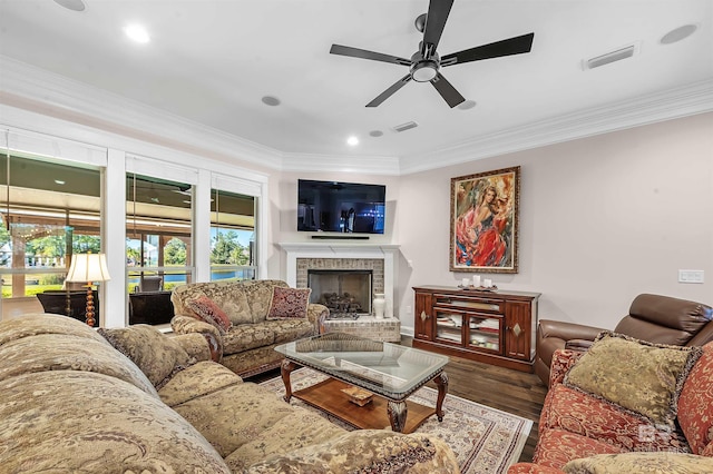 living room with wood finished floors, visible vents, ceiling fan, and ornamental molding
