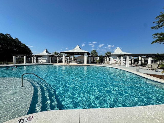 view of swimming pool with a gazebo and a patio area