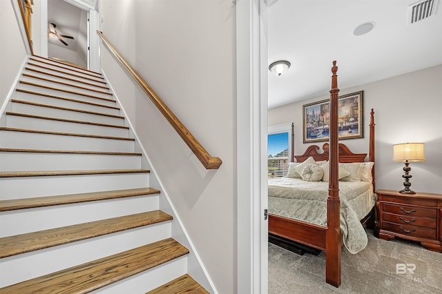 staircase featuring visible vents and carpet