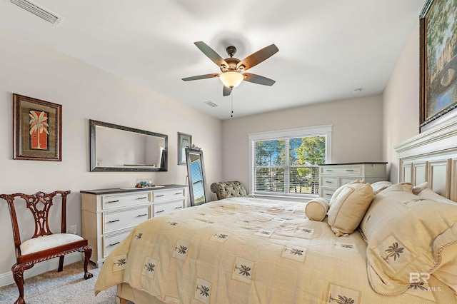 carpeted bedroom featuring visible vents, a ceiling fan, and baseboards