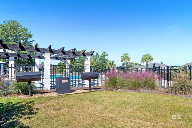 view of play area featuring fence and a lawn