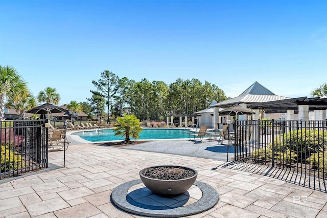pool featuring fence and a patio area