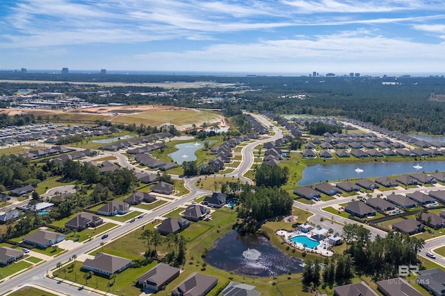 drone / aerial view with a water view and a residential view