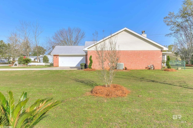 view of home's exterior with a garage, cooling unit, and a lawn