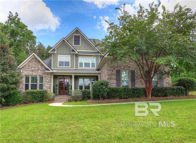 craftsman inspired home with a front lawn, board and batten siding, and brick siding