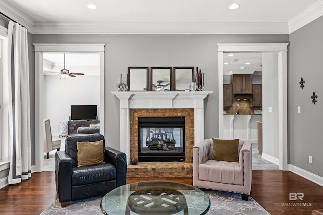 living area featuring crown molding, baseboards, dark wood finished floors, and a multi sided fireplace