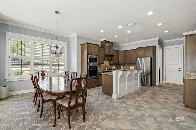 kitchen with light stone countertops, crown molding, stainless steel appliances, decorative backsplash, and pendant lighting