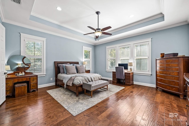 bedroom featuring a raised ceiling, dark wood finished floors, and baseboards