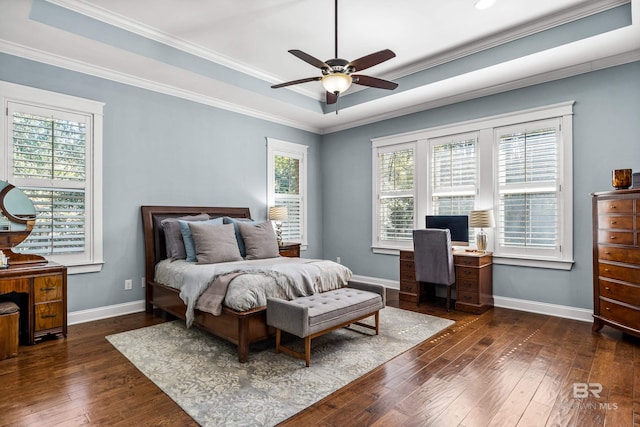 bedroom featuring dark wood-style floors, a tray ceiling, and baseboards