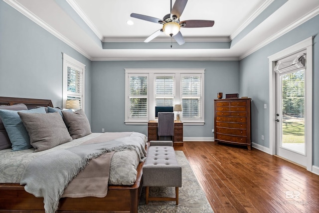 bedroom featuring access to exterior, dark wood-style floors, a raised ceiling, and ornamental molding