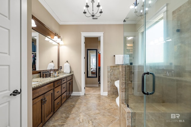 full bath featuring double vanity, a stall shower, baseboards, crown molding, and a sink