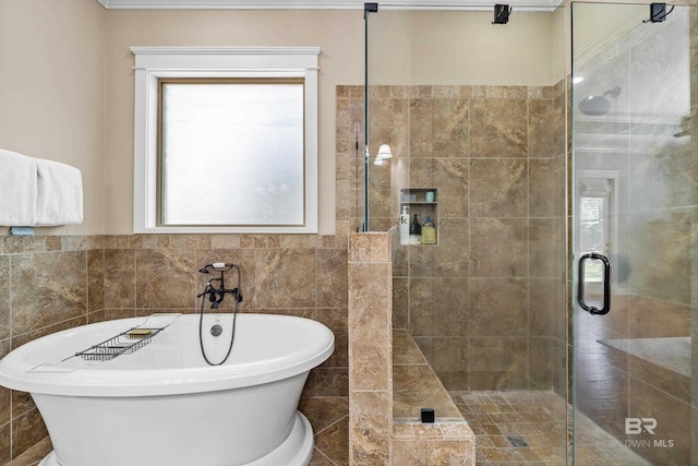 bathroom with a stall shower, tile walls, and a freestanding bath