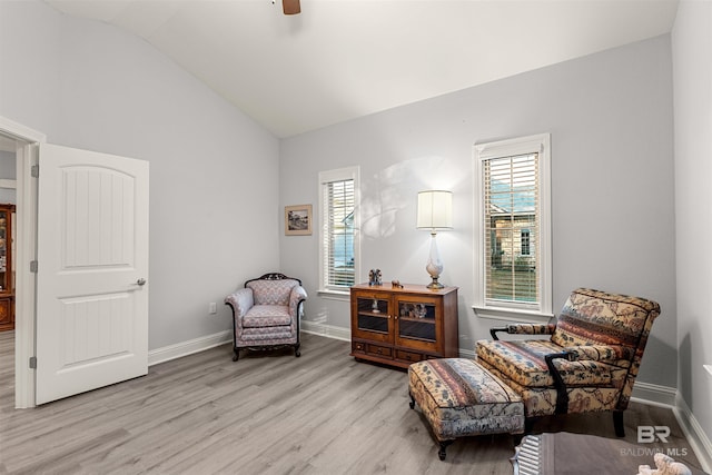 sitting room featuring ceiling fan, light hardwood / wood-style floors, and vaulted ceiling