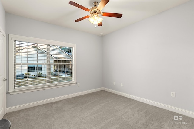 carpeted spare room with ceiling fan