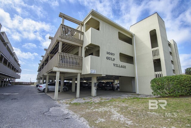 view of building exterior with parking