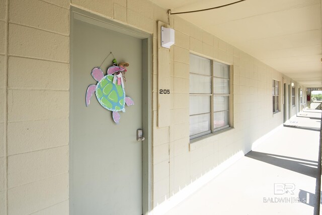 doorway to property featuring concrete block siding