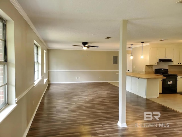 unfurnished living room featuring wood finished floors, ceiling fan, baseboards, crown molding, and a textured ceiling