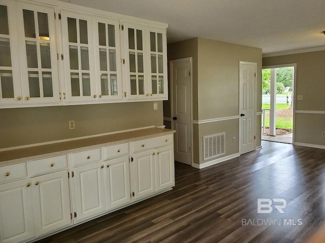 kitchen with baseboards, white cabinets, glass insert cabinets, and dark wood-style flooring