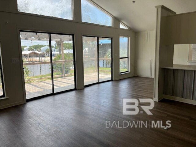 26225 Marina Rd, Orange Beach, AL 36561 - unfurnished room featuring dark wood-style floors, high vaulted ceiling, and baseboards